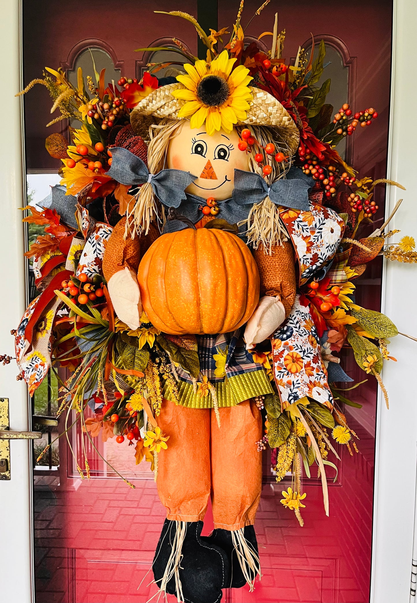 Large scarecrow girl with pumpkin wreath